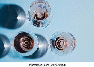 Rose wine glasses on colored background
