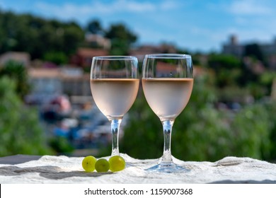 Rose Wine Of Provence, France, Served Cold On Outdoor Terrace In Two Wine Glasses In Sunny Day