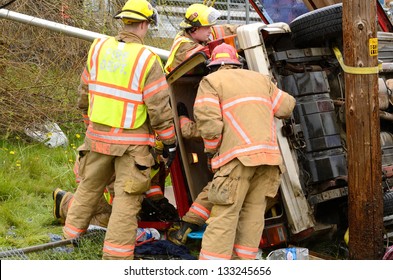 ROSEBURG, OR - MARCH 2013: Emergency Workers At The Scene Of A Single Car, Rollover Accident During A Spring Rain In Roseburg Oregon, March 19, 2013