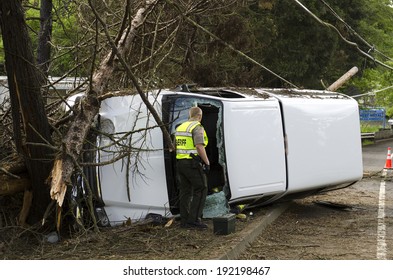 ROSEBURG, OR, USA - APRIL 25, 2014: Fire Fighters And Police At A Single Vehicle Accident That Rolled And Hit A Power Pole And Trees Resulting In Minor Injuries To The Driver.