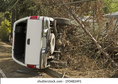 ROSEBURG, OR, USA - APRIL 25, 2014: Fire Fighters And Police At A Single Vehicle Accident That Rolled And Hit A Power Pole And Trees Resulting In Minor Injuries To The Driver.