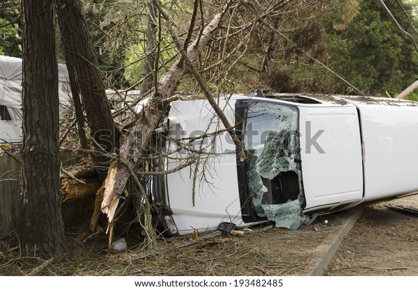ROSEBURG, OR,\
USA - APRIL 25, 2014: Fire fighters and police at a single vehicle\
accident that rolled and hit a power pole and trees resulting in\
minor injuries to the\
driver.