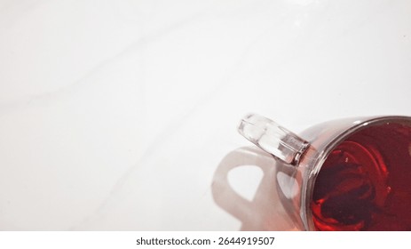 Roselle tea, a vibrant ruby-red herbal infusion, served in a glass. This refreshing beverage, made from hibiscus flower calyces, offers a distinct tangy and subtly sweet flavor. It's a healthy, natura