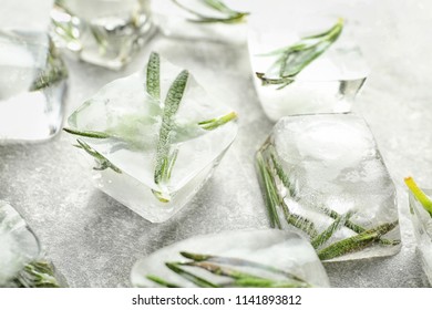 Rosemary frozen in ice cubes on light grey background - Powered by Shutterstock