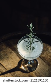 Rosemary Gin Vodka Gimlet Herbal Cocktail In Coupe Glass Atop Wooden Barrel