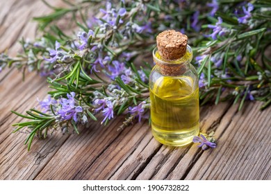 Rosemary herbal essential oil on the wooden background