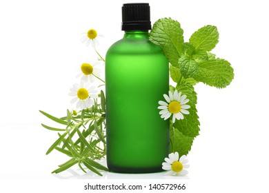 Rosemary, mint and chamomile flower with essential oil  glass bottle, isolated on white background.