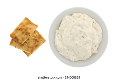 Rosemary And Olive Oil Seasoned Crackers To The Side With A Bowl Of French Onion Dip Isolated On A White Background.