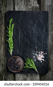 Rosemary, Salt And Pepper On Wooden Cutting Board, Copy Space. Cooking Food Background