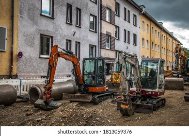 Rosenheim, Germany - April 27, 2019: Tractors and bulldozers are renovating a road on an old street in the town of Rosenheim