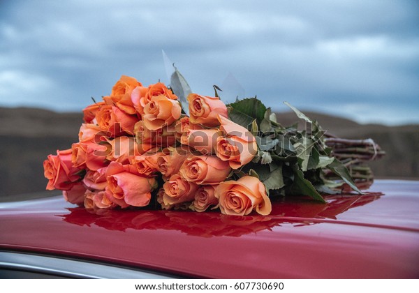 Roses are lying on top of the\
car