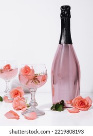 Roses In Pink Champagne Glasses With Champagne Bottle