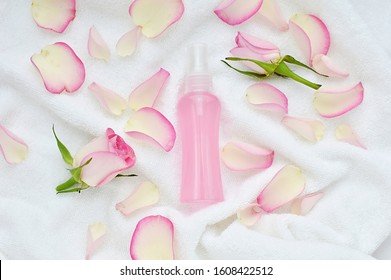 Roses Water In Spray Bottle, Natural Facial Toner, Make Up Remover, Rose Petals, Beauty Flat Lay On White Towel.