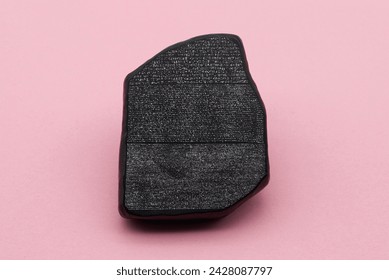 The Rosetta Stone model isolated on pink background.