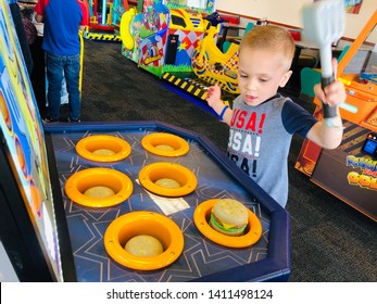 Roseville, CA - May 25, 2019: Boy Playing A Whack A Mole Burger Game Inside Chuck E Cheese.