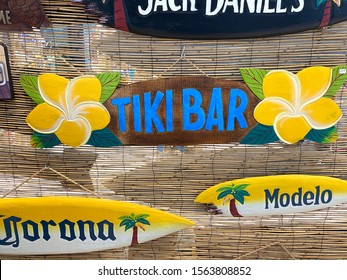 Roseville, CA - November 17, 2019: Tiki Bar, Modelo And Corona Beer Signs Against A Woven Drape.