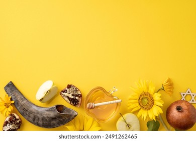 Rosh Hashanah Jewish holiday concept with shofar, apples, honey, pomegranates, sunflowers, and Star of David on a yellow background - Powered by Shutterstock