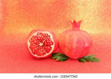 Rosh hashanah (jewish New Year holiday) concept. Pomegranate raditional symbol over red glitter background