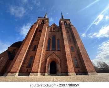 Roskilde Cathedral, historical building, architecture, religion, denmark, copenhagen, gorgeous building, building with red stones, high building, rising up to the sky, bottom up angle   - Shutterstock ID 2307788859