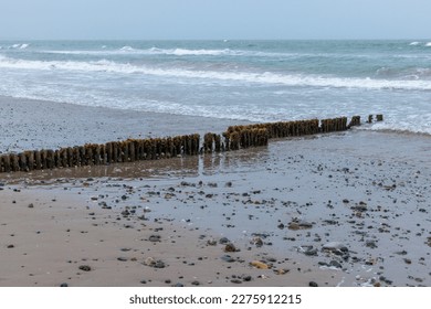 Rosslare Beach, Ireland  A rainy, wet, misty summer morning - Groynes or Groins jutting out into the sea at low tide - Powered by Shutterstock