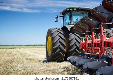 Rostov-on-Don, Russia - 06.09.2022: Close-up rear view of a large modern tractor plows a piece of land in a field. New models of agricultural machinery at the Day of the Field exhibition. - Shutterstock ID 2178587181