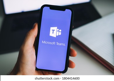Rostov-on-Don / RUSSIA - August 27 2020 : hand holding iPhone with Microsoft Teams video call app logo on the screen.