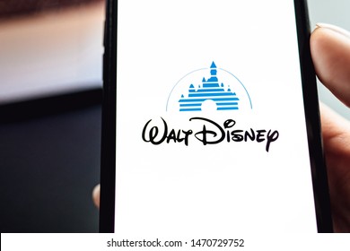 ROSTOV-ON-DON / RUSSIA - August 5 2019: Hand Holding The IPhone X With Disney Logo On The Screen. Disney Background 