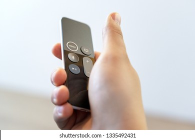 ROSTOV-ON-DON, RUSSIA - DECEMBER 20, 2018: A Man Remotely Controlling His Apple TV Device Console Siri  Remote