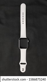 Rostov-on-Don, Russia - December 2019. Apple Watch Series 5 Silver Aluminum Case with Sport Band White color. New smart watches from APPLE on a black surface made of leather.