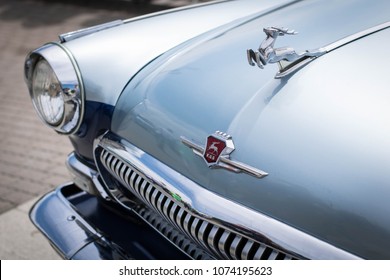 Rostov-on-Don / Russia - May 20th, 2017: Mascot, hood, headlight and grille of bi-color customised soviet classic car, Volga Gaz-21 at Retro Motor Show
