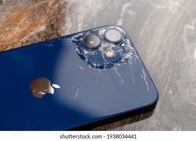 Rostov-on-Don, Russia - November  2020. IPhone 12 on marble surface. Close-up of a smartphone with a broken case.