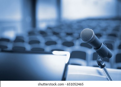 Rostrum with microphone and computer in conference hall