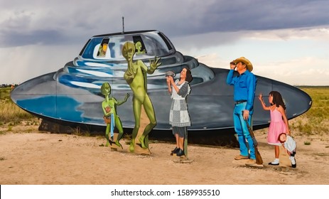 ROSWELL, NEW MEXICO - OCTOBER 8, 2019:  Roswell, New Mexico Welcome Sign Cutouts With A Alien And Human Family Encounter, And A Flying Saucer Spaceship.