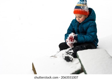 Rosy Cheeked Boy Making Snowball