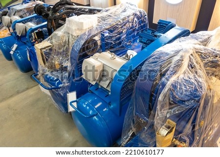 Rotary air compressor, direct drive system, produces air quickly. use piston lubricant easy maintenance in a building material store. Stockfoto © 