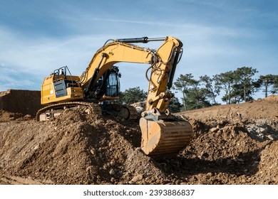 Rotary backhoe excavating earth for the construction of a road