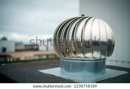 Rotary deflectors on the apartment house rooftop.
