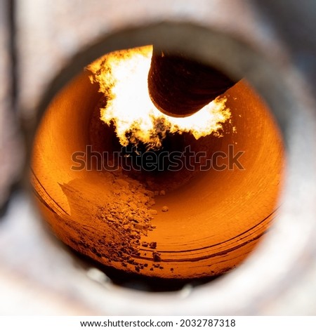 Rotary kiln for clinker production in cement plant, close up view through inspection hole