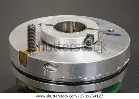 Rotary part of an encoder lying on a workbench.