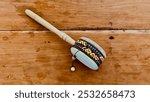 Rotary pellet drum, or isolated rattle drum made of brown wood. brown wood background, This traditional musical instrument comes from Africa