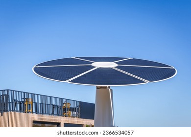 Rotating solar panel in flower shape in a city. Photovoltaic, alternative electricity source - Shutterstock ID 2366534057