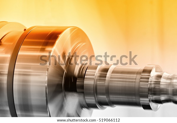 Rotating spindle of turning lathe and metal\
detail. Selective\
toning.