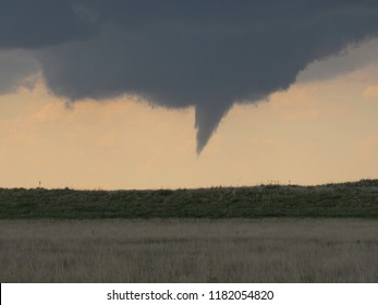 A Rotating Wall Cloud And Funnel Cloud Are The Prelude Of A Storm That Would Soon Produce A Large Tornado. Taken In The Texas Panhandle. 