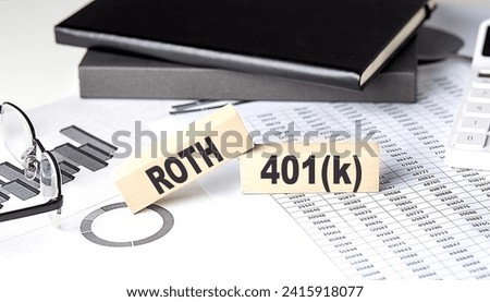 ROTH 401K - text on wooden block with chart and notebook