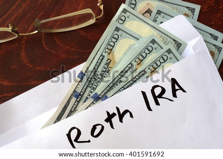 Roth IRA written on an envelope with dollars. Savings concept.