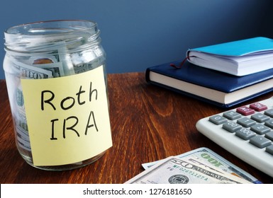 Roth Ira Written On A Label Of The Jar With Money.