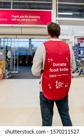 ROTHERHAM, UK – NOVEMBER 22, 2019: A Volunteer Stands At The Supermarket Entrance At The Tesco National Food Bank Collection For Christmas