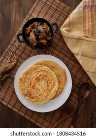 Roti Canai Or Roti Parata With Beef Curry Sauce, Top View