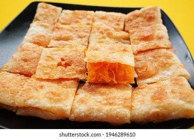 Roti With Sweet Egg Floss On Black Dish.