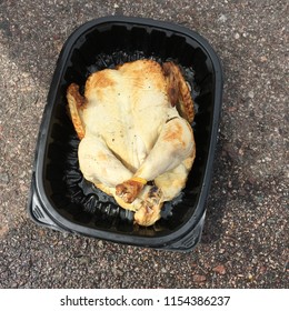 Rotisserie Chicken In Black Container In Parking Lot